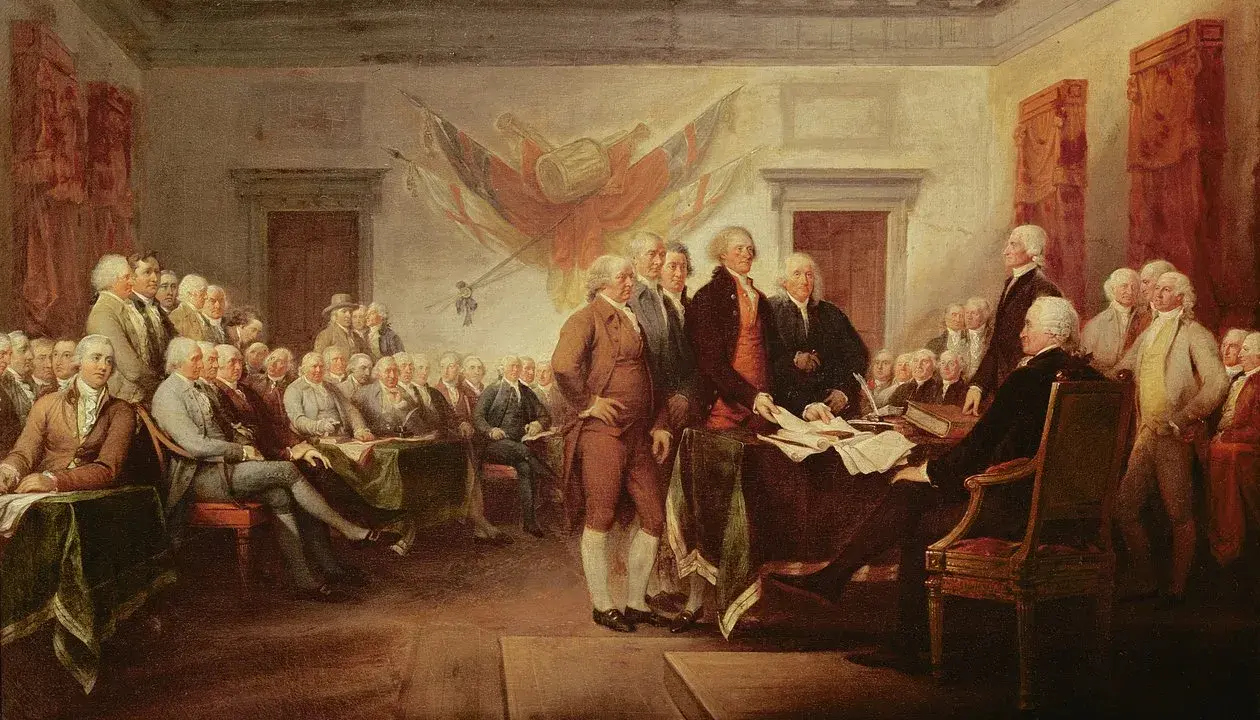 Männer in historischen Kostümen versammeln sich, um die amerikanische Unabhängigkeitserklärung zu unterzeichnen.