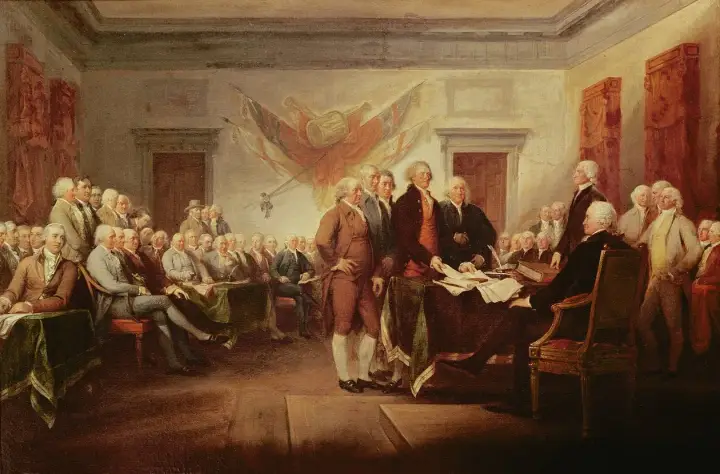 Männer in historischen Kostümen versammeln sich, um die amerikanische Unabhängigkeitserklärung zu unterzeichnen.